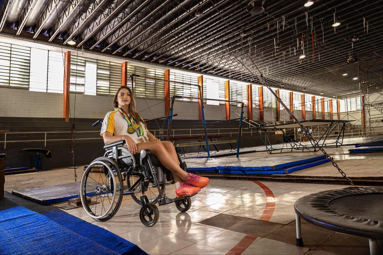 mulher de cadeira de rodas no meio de um ginásio